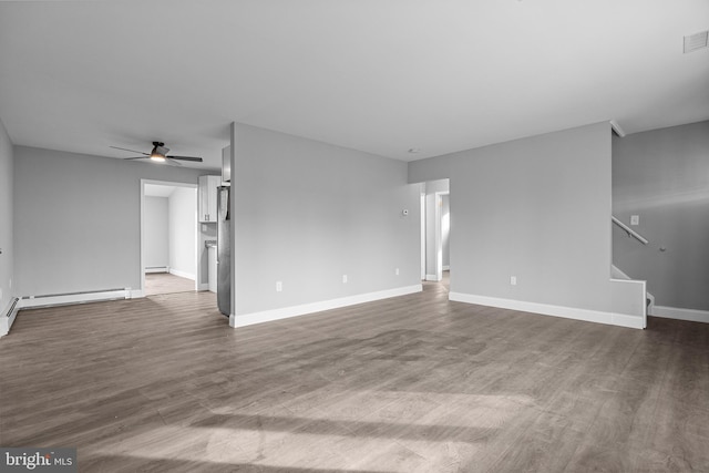 unfurnished living room featuring baseboards, dark wood-style flooring, ceiling fan, stairs, and a baseboard heating unit