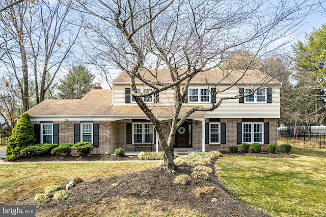 view of front facade featuring fence, roof with shingles, a chimney, a front lawn, and brick siding