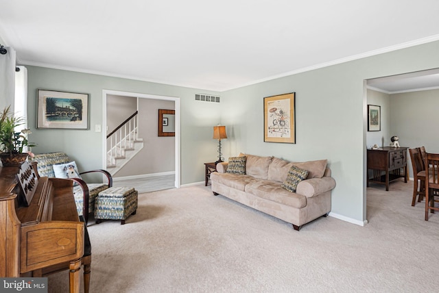 carpeted living area featuring visible vents, baseboards, ornamental molding, and stairway