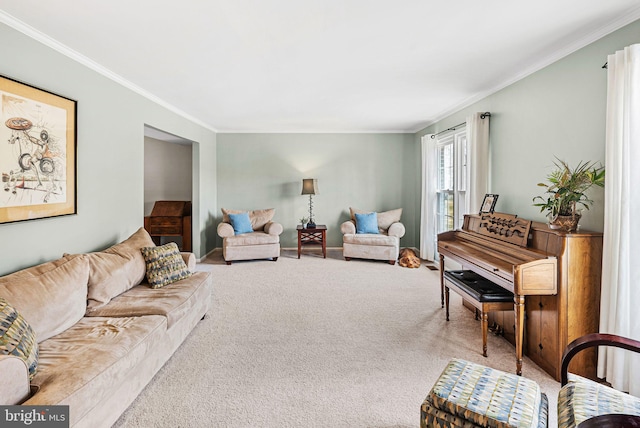 living area with crown molding, carpet flooring, and baseboards