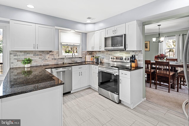 kitchen featuring a sink, visible vents, appliances with stainless steel finishes, and white cabinets