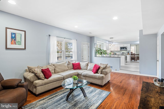 living area with a wealth of natural light, recessed lighting, and light wood finished floors