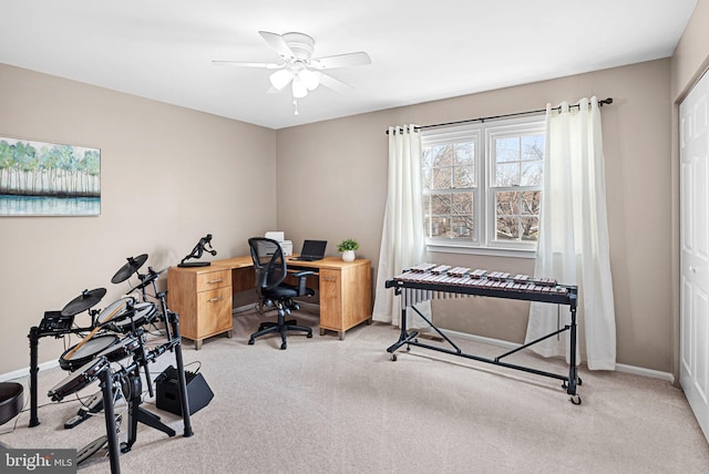 office area featuring carpet flooring, baseboards, and ceiling fan