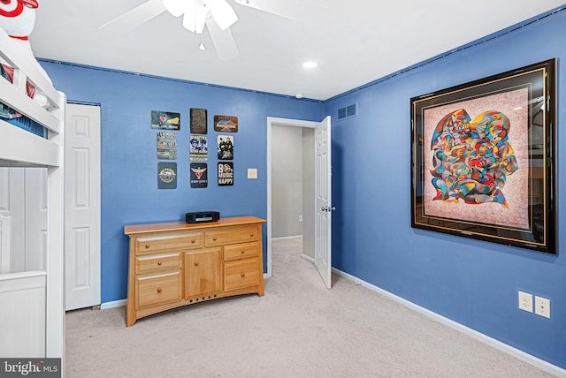 bedroom with visible vents, light colored carpet, a ceiling fan, and baseboards