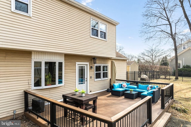 wooden deck with outdoor lounge area, outdoor dining space, and fence