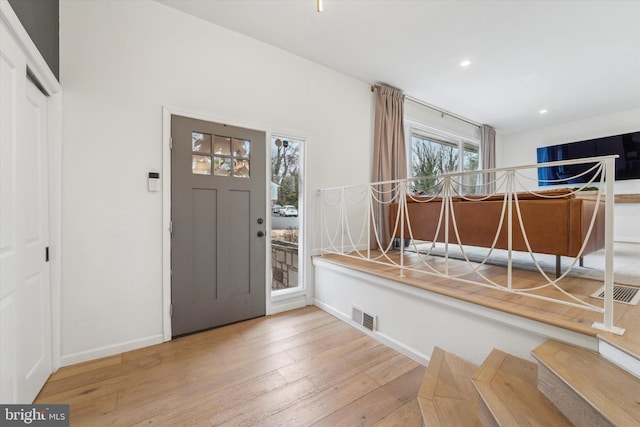 entryway featuring recessed lighting, visible vents, wood-type flooring, and baseboards