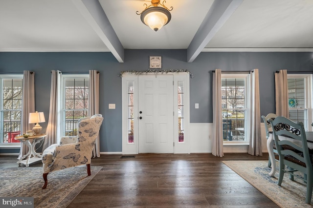 entrance foyer with beamed ceiling, plenty of natural light, and wood finished floors