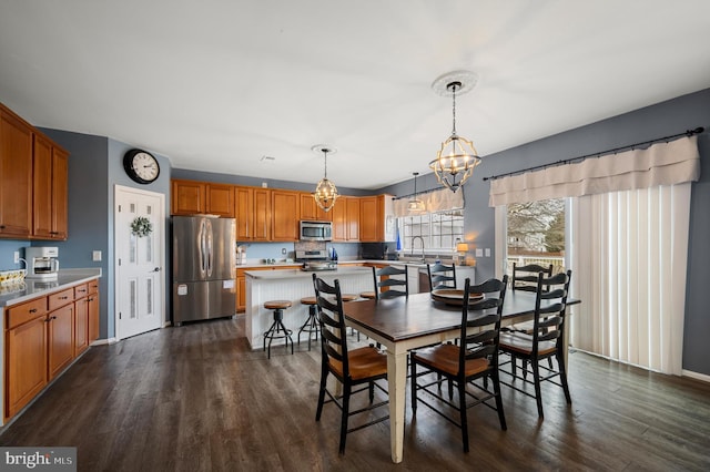 dining area with dark wood finished floors and a notable chandelier