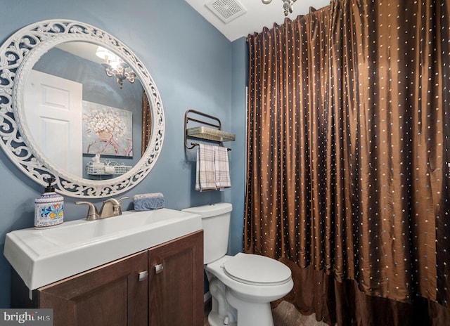 bathroom with vanity, vaulted ceiling, toilet, and visible vents