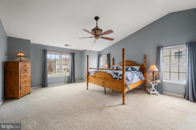 carpeted bedroom with lofted ceiling, baseboards, visible vents, and ceiling fan