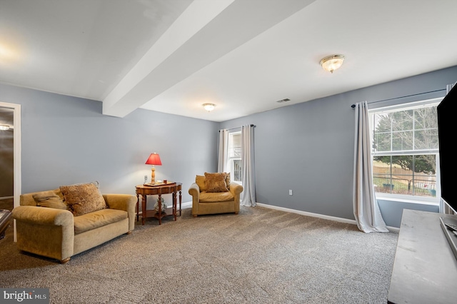 sitting room featuring beamed ceiling, carpet, visible vents, and baseboards