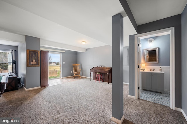 interior space featuring carpet flooring and baseboards