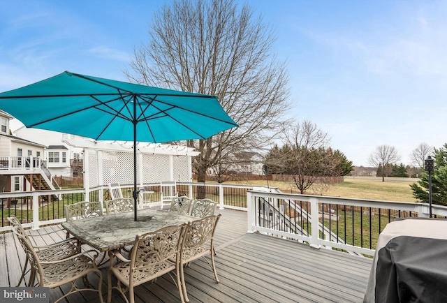 deck featuring outdoor dining area and a grill