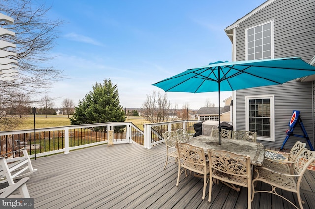 deck featuring outdoor dining space and a grill