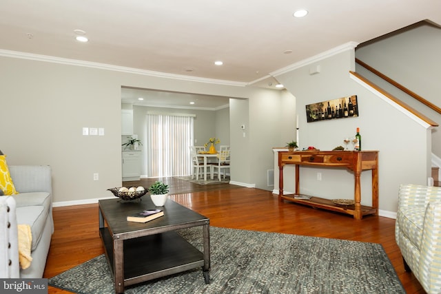 living room with crown molding, baseboards, stairs, recessed lighting, and wood finished floors