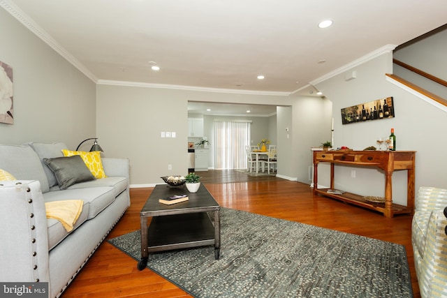 living room featuring stairway, wood finished floors, baseboards, recessed lighting, and crown molding