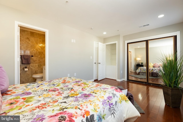 bedroom with visible vents, recessed lighting, ensuite bathroom, wood finished floors, and a closet