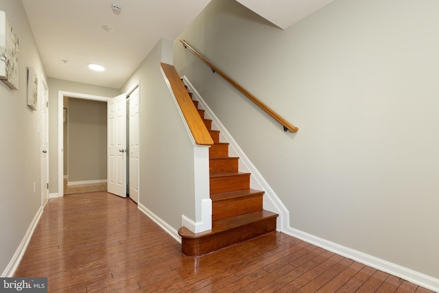 stairs featuring baseboards and hardwood / wood-style floors