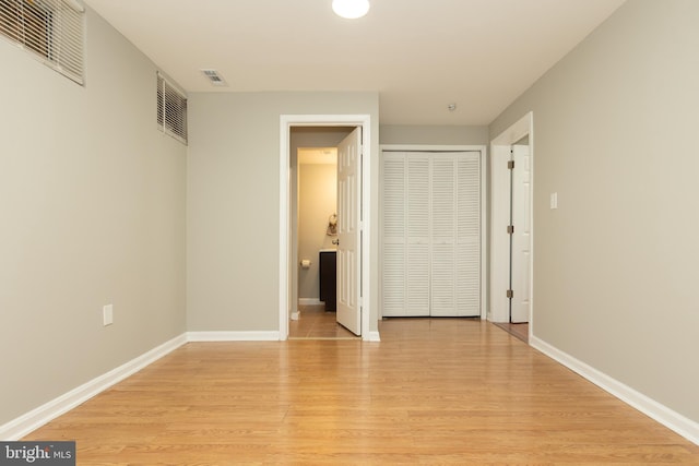 unfurnished bedroom with visible vents, baseboards, and light wood-style flooring