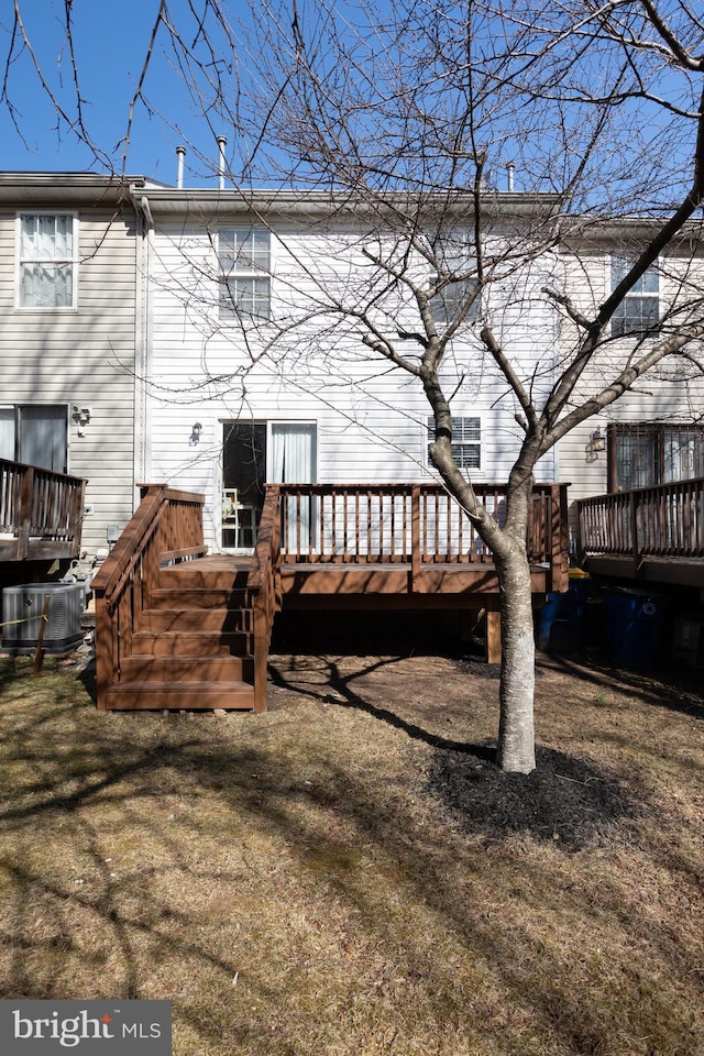 rear view of property with central air condition unit and a wooden deck