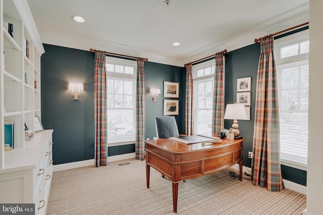 office space featuring baseboards, plenty of natural light, crown molding, and light carpet