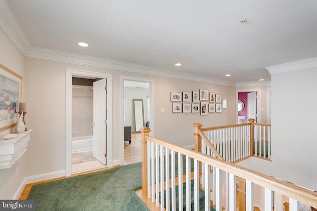 corridor featuring recessed lighting, crown molding, and an upstairs landing