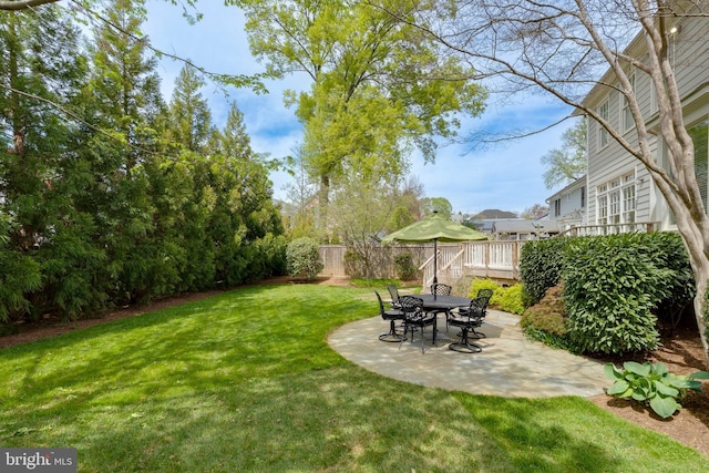view of yard with fence and a patio