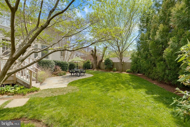 view of yard with a patio area, fence, and stairway