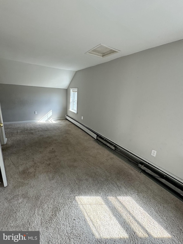 additional living space with carpet flooring, attic access, a baseboard heating unit, and lofted ceiling