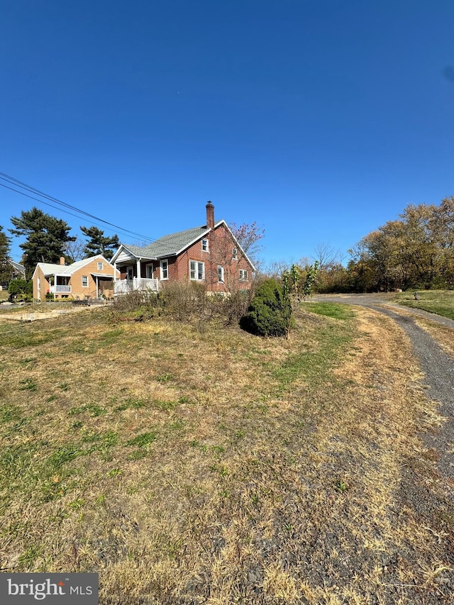 view of property exterior with a chimney