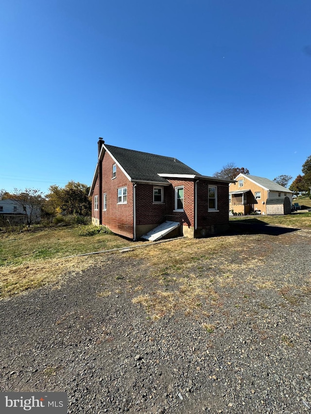 rear view of property featuring brick siding