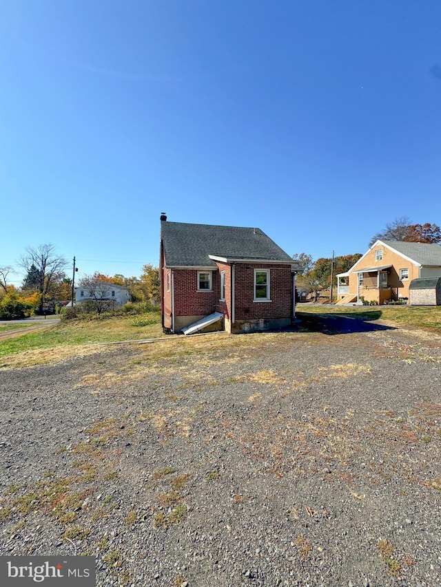 bungalow-style house with brick siding