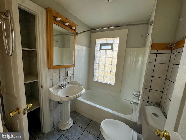 full bath featuring tile patterned floors, shower / bathing tub combination, toilet, and tile walls