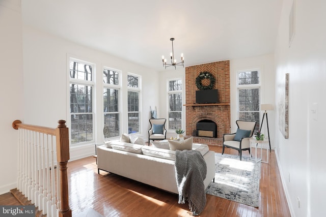 living area with a fireplace, hardwood / wood-style flooring, and a healthy amount of sunlight