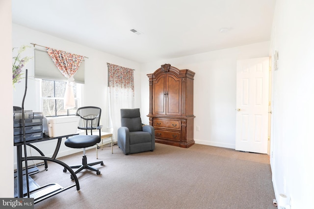 living area with visible vents, baseboards, and carpet floors