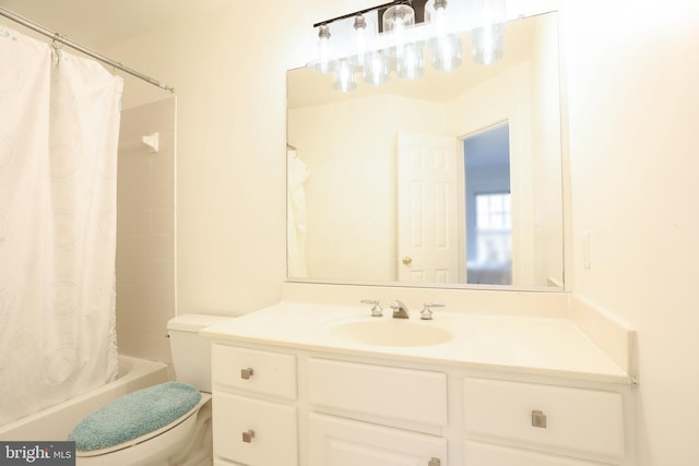 bathroom featuring vanity, shower / bath combination with curtain, and toilet