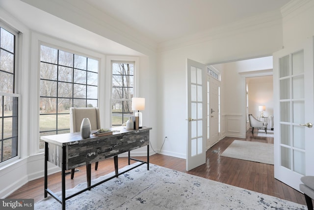 office space with hardwood / wood-style floors, a decorative wall, french doors, and ornamental molding