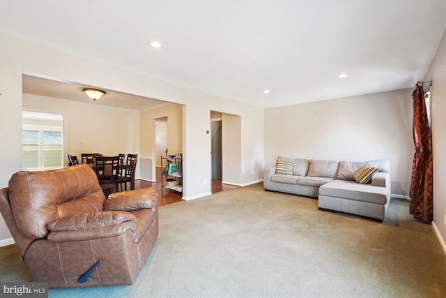 carpeted living room featuring recessed lighting, baseboards, and ornamental molding