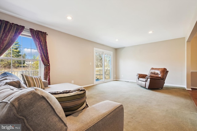 carpeted living room with recessed lighting and baseboards