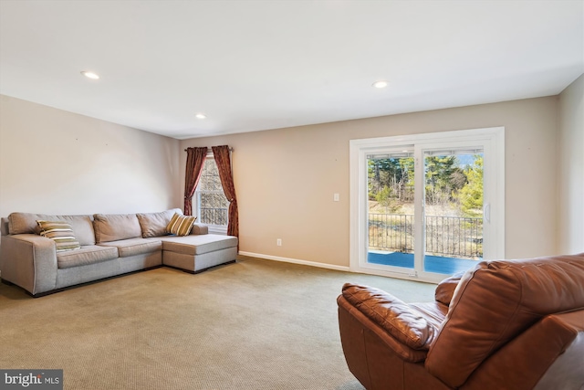 living area featuring recessed lighting, baseboards, and carpet flooring