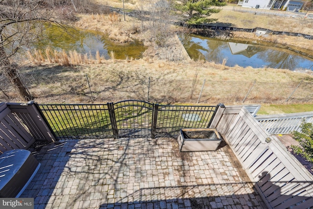 exterior space with fence and a water view