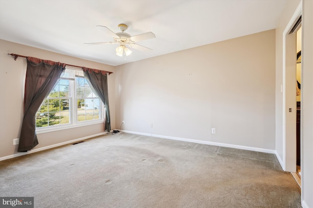 empty room with visible vents, ceiling fan, baseboards, and carpet floors