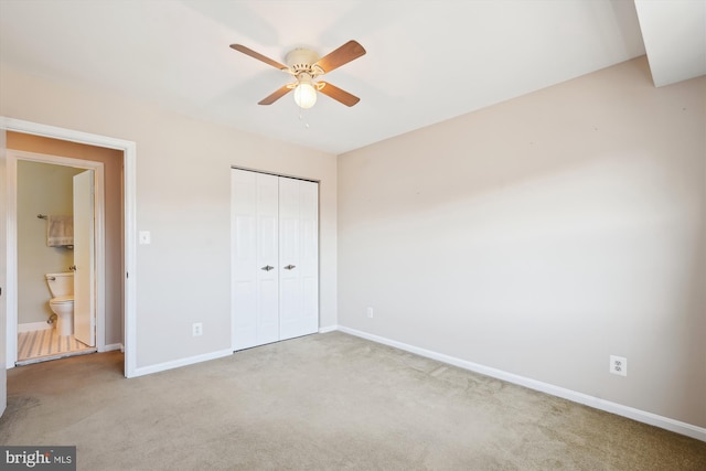 unfurnished bedroom with a closet, baseboards, and carpet