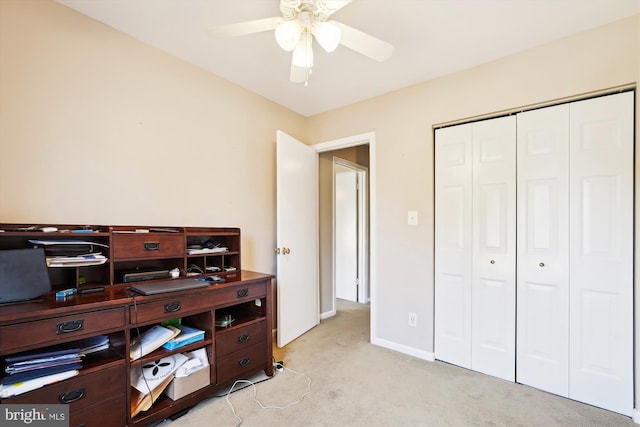 office area with light carpet, baseboards, and a ceiling fan