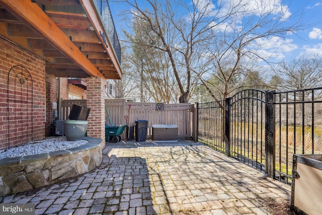 view of patio featuring a gate and fence