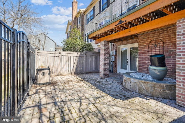 view of patio with french doors and fence private yard