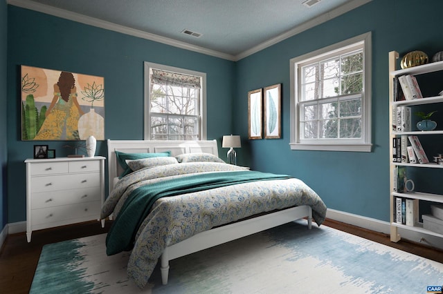 bedroom featuring crown molding, baseboards, visible vents, and dark wood-style flooring