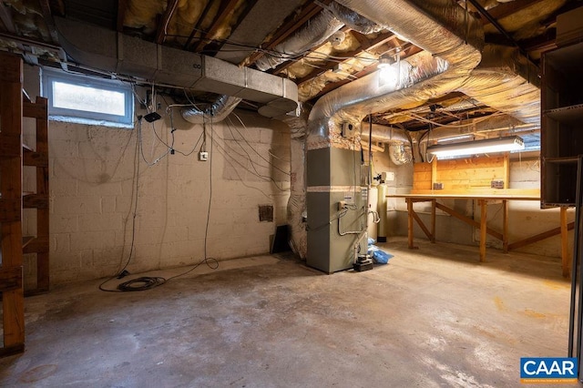 basement with gas water heater and heating unit