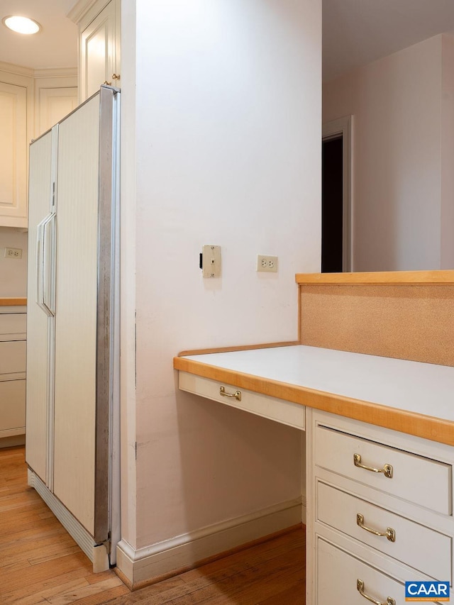 bathroom with baseboards and wood finished floors