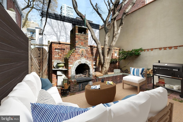 view of patio featuring an outdoor living space with a fireplace